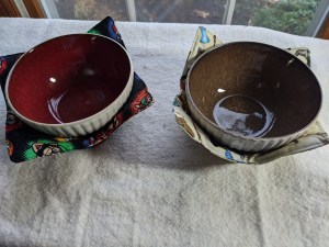 Image is of two bowls in bowl cozies with the label Bowl Buddies